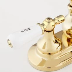 Signature Hardware Teapot Centerset Bathroom Faucet with Small Porcelain Lever Handles and Pop-Up Drain Assembly -Central Brass store signature hardware 918942 handle close up view 404